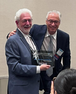 Howard receiving a plaque for his service as President of the AAA-CPA